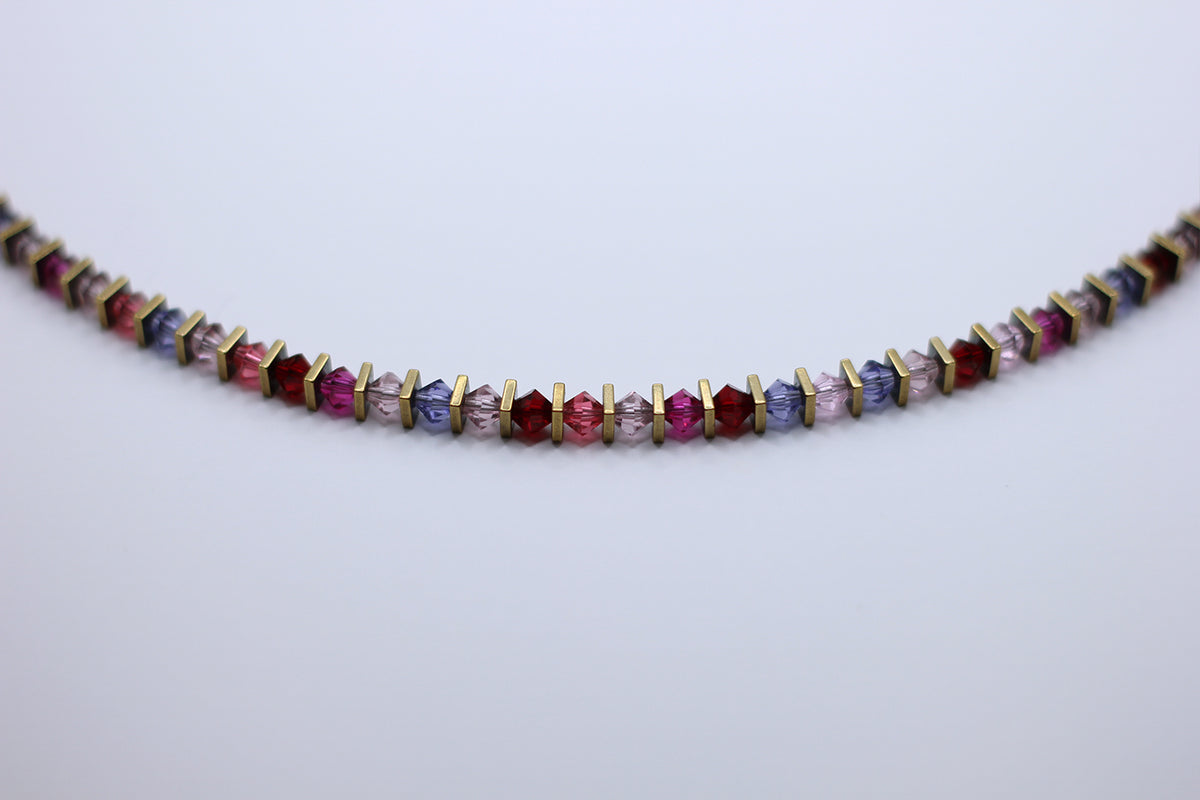 Multicolored beaded necklace on a light gray background